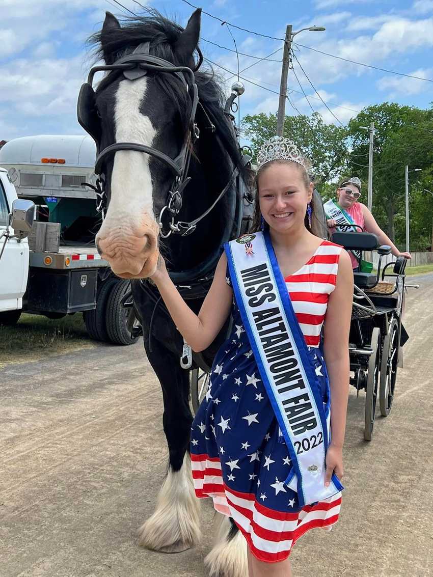 Miss Altamont Fair 2022 with shire hitched to carriage